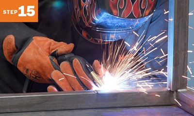 close up of welder mig welding metal tubing