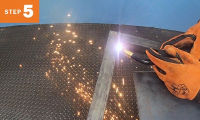 closeup image of MIG welding two pieces of tubing