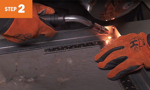 Operator welds a corner piece.
