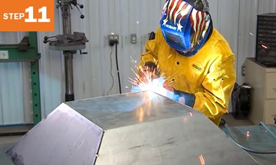 welder welding a metal fire pit