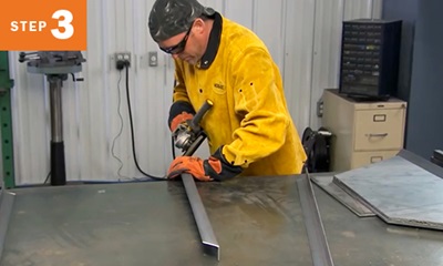 welder grinding the edges of metal