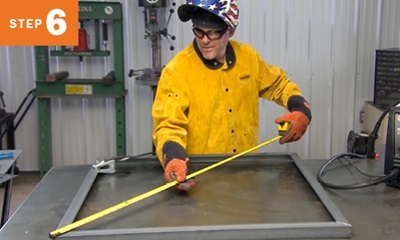 Welder measuring metal