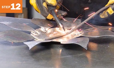welding a round bar to sunflower metal art project