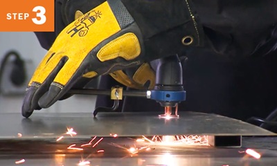 Closeup of cutting metal with a plasma cutting torch